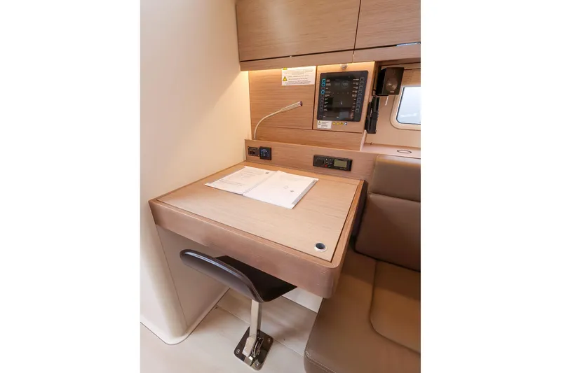 Slide: The Image of 2025 Hanse 458 yacht interior with navigation desk and control panel. - 25