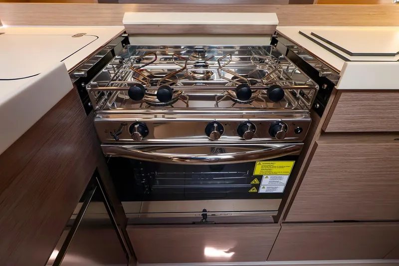 Slide: The Image of Modern kitchen stove in 2025 Hanse 458 yacht, featuring sleek design and stainless steel finish. - 26