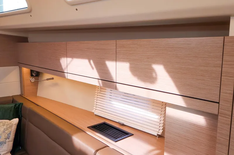 Slide: The Image of Interior of 2025 Hanse 458 yacht with modern wood cabinetry and window blinds. - 32