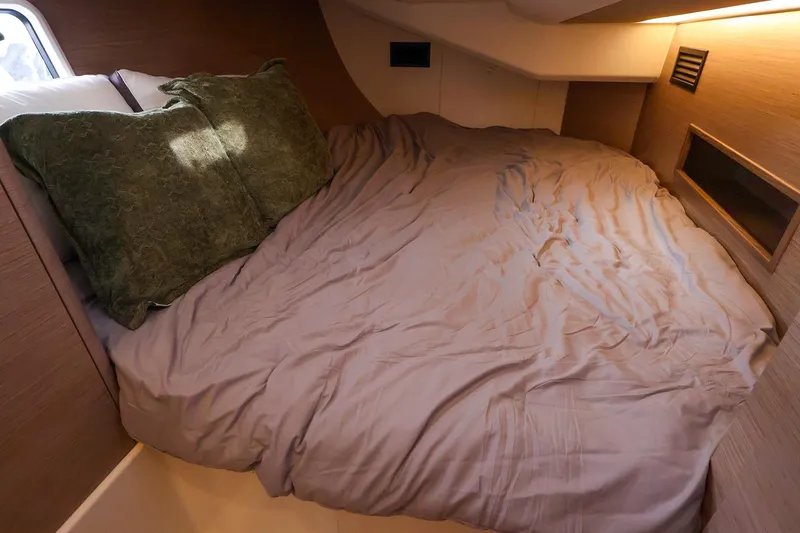 Slide: The Image of Cozy cabin bed in 2025 Hanse 458 yacht with green pillows and soft lighting. - 36
