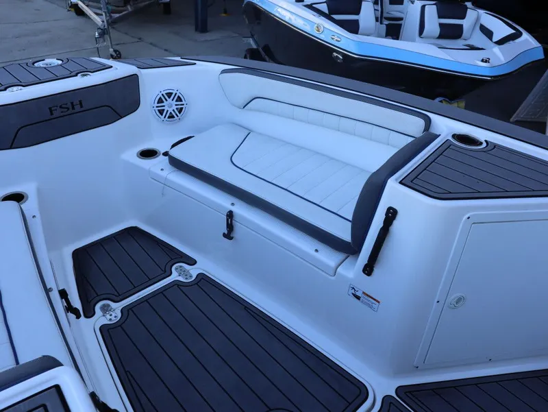 Slide: The Image of 2019 Yamaha Boats 210 FSH Sport interior with seating and speaker detail. - 11