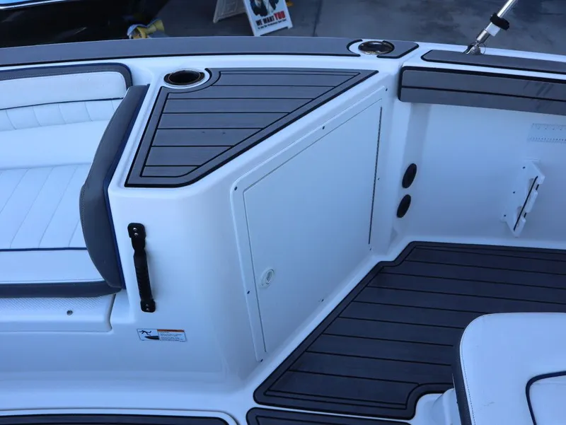 Slide: The Image of 2019 Yamaha Boats 210 FSH Sport interior with seating and storage compartments. - 12