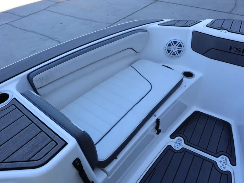 Slide: The Image of 2019 Yamaha Boats 210 FSH Sport interior seating with speaker and cup holder. - 13