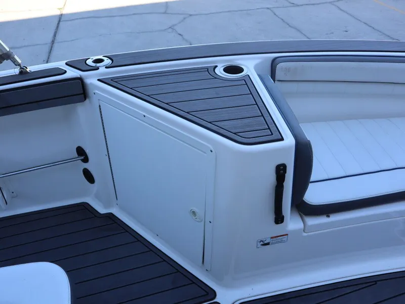Slide: The Image of 2019 Yamaha Boats 210 FSH Sport interior with seating and storage compartment. - 14