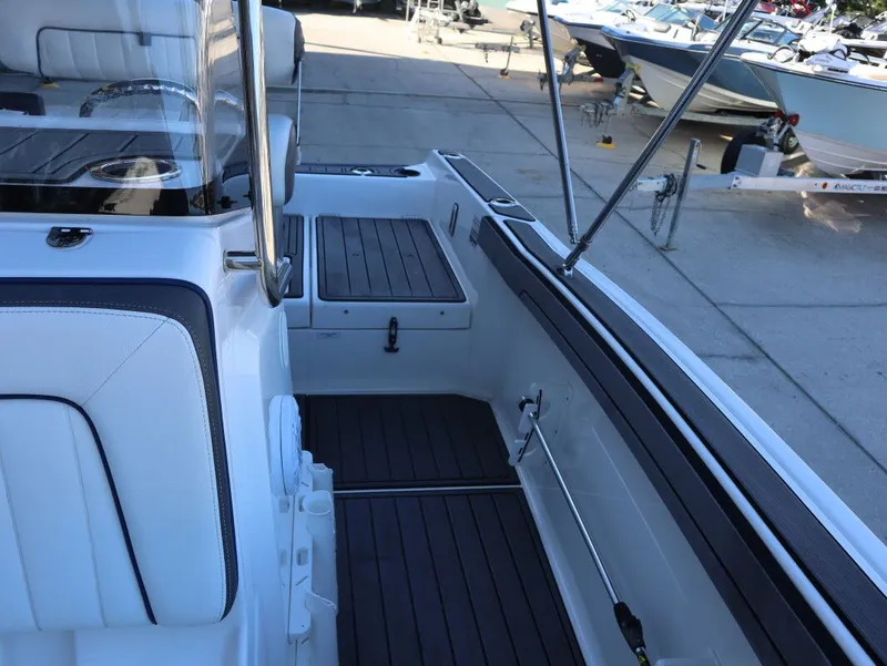 Slide: The Image of 2019 Yamaha Boats 210 FSH Sport interior with sleek seating and deck design. - 17