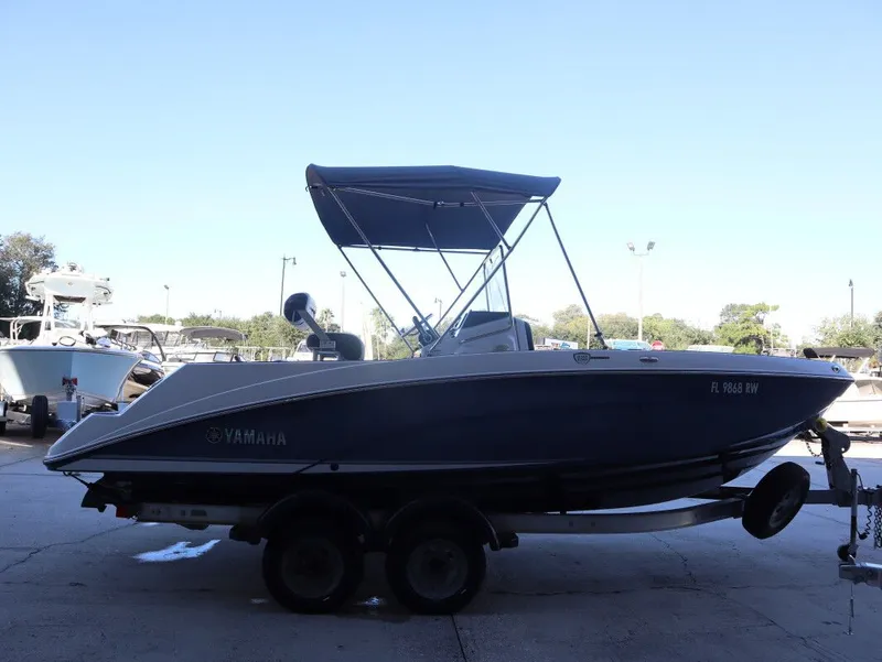 Slide: The Image of 2019 Yamaha Boats 210 FSH Sport on trailer, parked outdoors. - 3