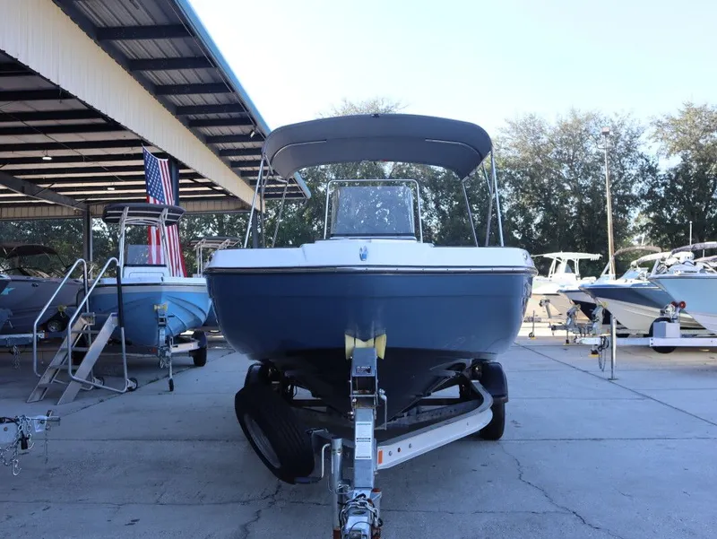 Slide: The Image of 2019 Yamaha Boats 210 FSH Sport on trailer at marina, under covered area. - 4