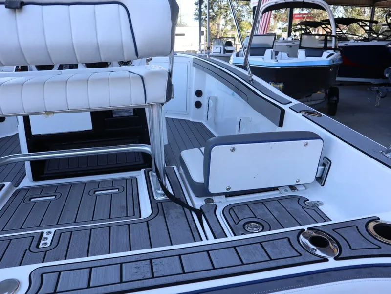 Slide: The Image of 2019 Yamaha Boats 210 FSH Sport interior with seating and deck details. - 6