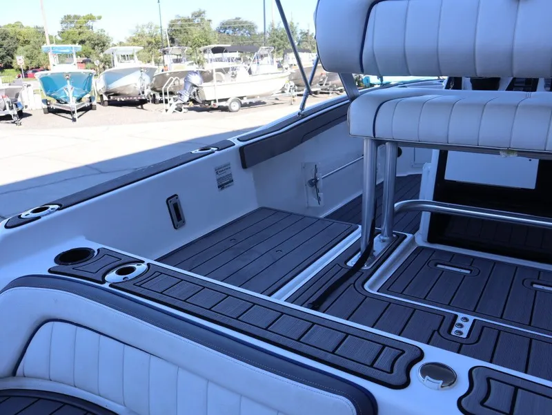 Slide: The Image of 2019 Yamaha Boats 210 FSH Sport interior with seating and deck details. - 7