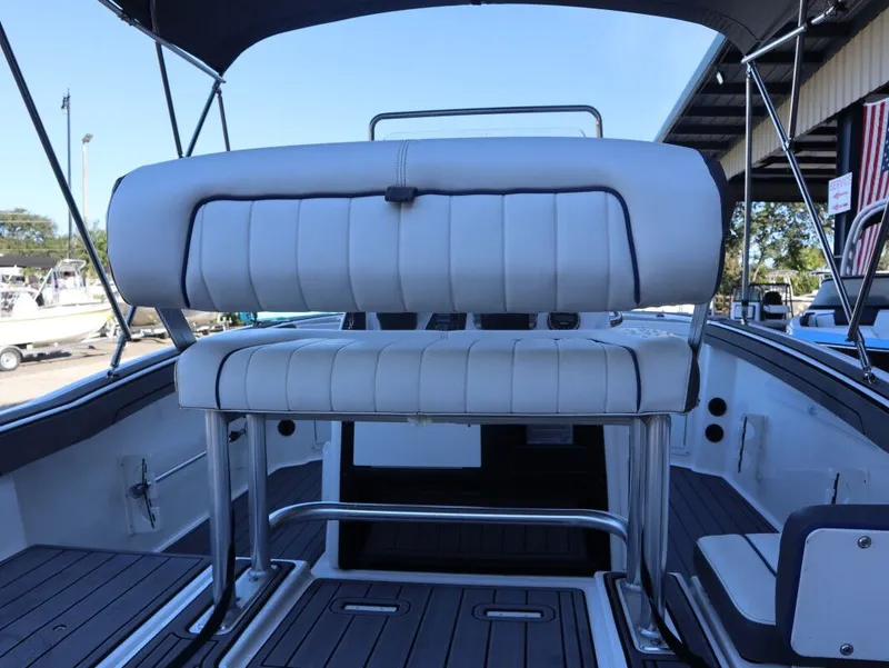 Slide: The Image of 2019 Yamaha Boats 210 FSH Sport interior with cushioned seating and sleek design. - 8