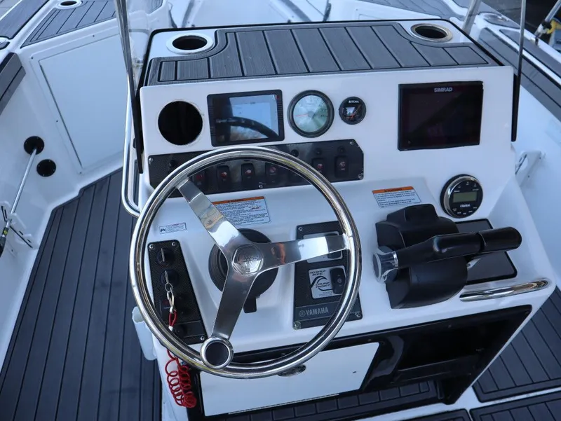 Slide: The Image of 2019 Yamaha Boats 210 FSH Sport dashboard with steering wheel and controls. - 9