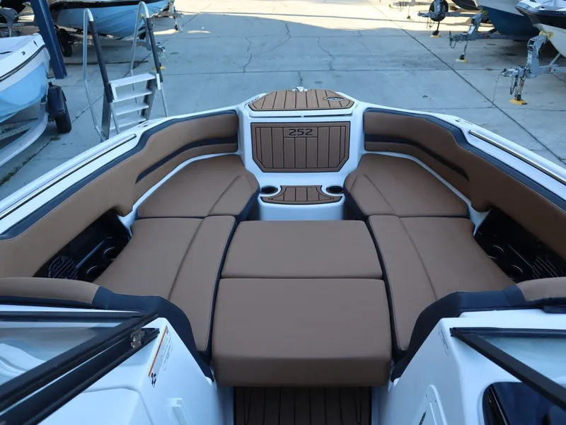 Slide: The Image of 2026 Yamaha Boats 252SD interior with tan seating and cup holders. - 10