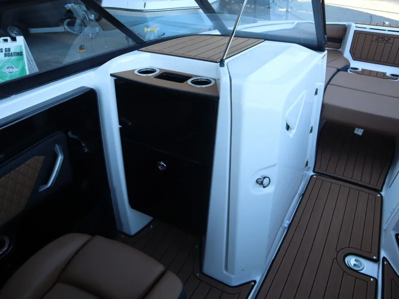 Slide: The Image of 2026 Yamaha Boats 252SD interior with brown seating and wood-style flooring. - 12