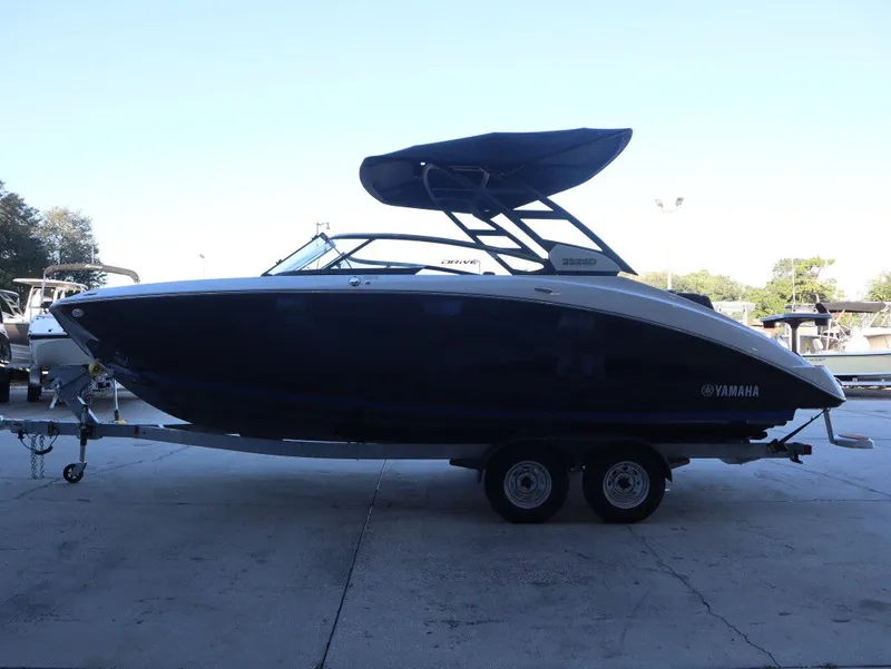 Slide: The Image of 2026 Yamaha Boats 252SD on trailer, side view, with canopy, outdoors. - 3