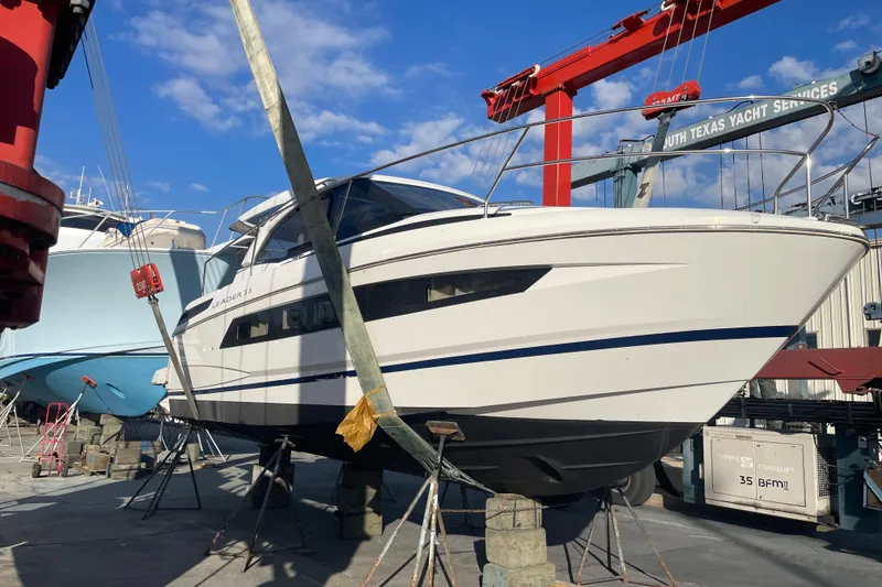 Slide: The Image of 2019 Jeanneau Leader 33 yacht docked under a covered marina. - 0