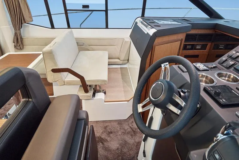 Slide: The Image of 2019 Jeanneau Leader 33 yacht interior with seating and table, docked at marina. - 10