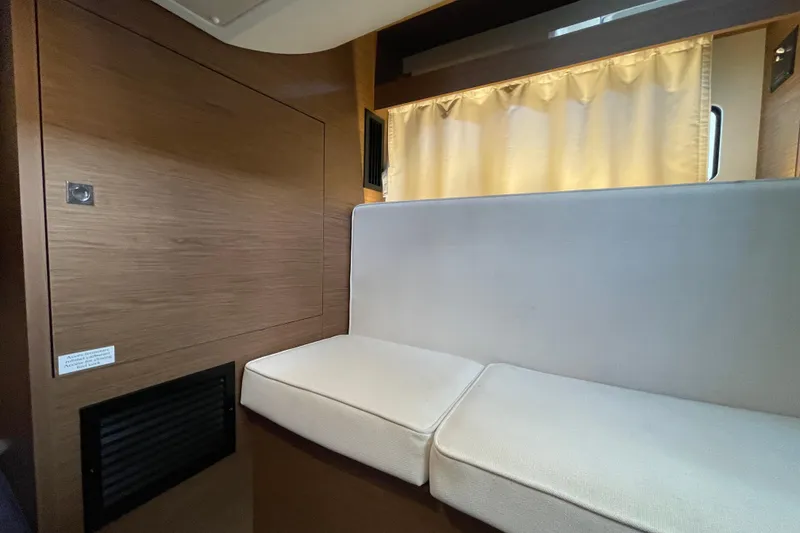 Slide: The Image of 2019 Jeanneau Leader 33 interior with modern kitchen and cozy seating area. - 21