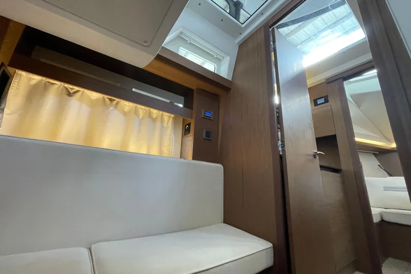 Slide: The Image of 2019 Jeanneau Leader 33 interior with modern kitchen and cozy seating area. - 22