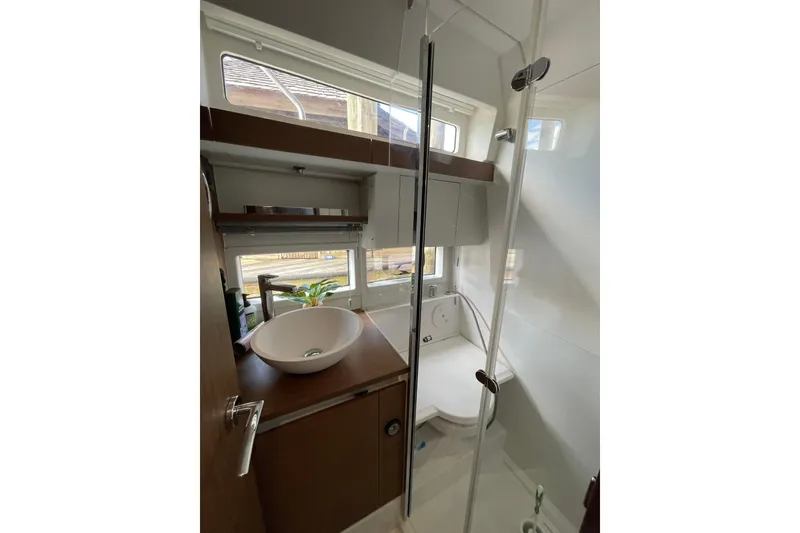 Slide: The Image of 2019 Jeanneau Leader 33 interior with cozy seating and elegant wooden table. - 25