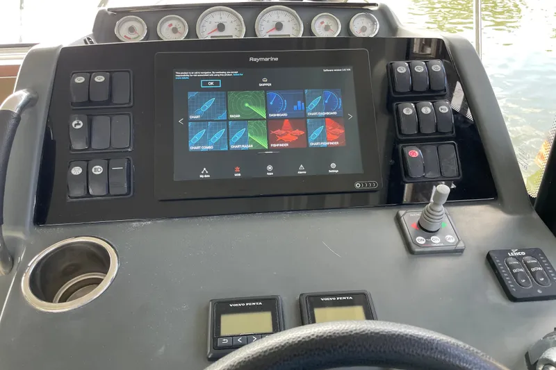 Slide: The Image of 2019 Jeanneau Leader 33 boat on lift at marina under blue sky. - 34