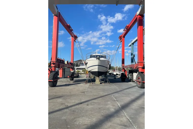 Slide: The Image of 2019 Jeanneau Leader 33 yacht docked in a marina under a wooden shelter. - 4