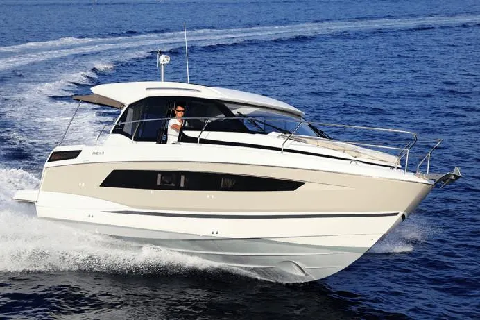 Slide: The Image of 2019 Jeanneau Leader 33 docked in a marina under a wooden shelter. - 5