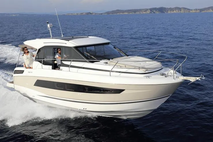 Slide: The Image of 2019 Jeanneau Leader 33 yacht docked in marina, featuring sleek design and spacious deck. - 6