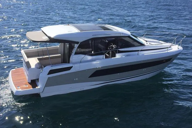 Slide: The Image of Interior of 2019 Jeanneau Leader 33 yacht with spacious seating and wooden table. - 7