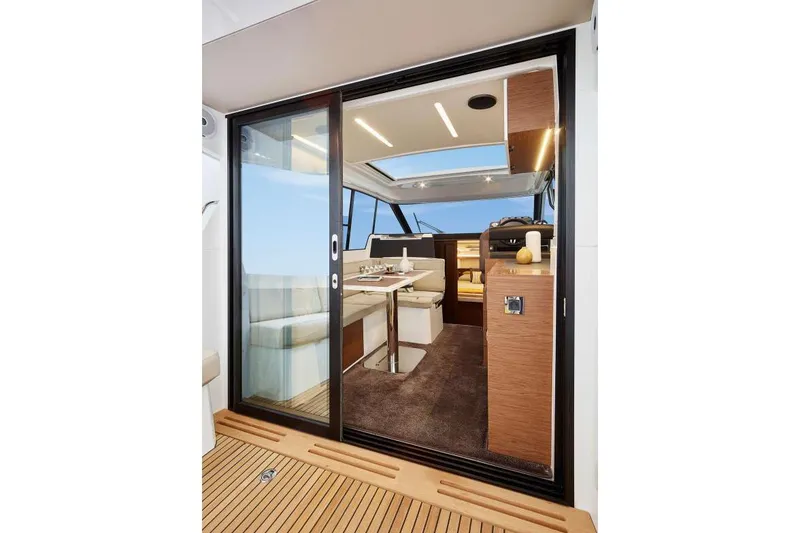 Slide: The Image of Interior view of 2019 Jeanneau Leader 33 yacht, featuring modern seating and sleek design. - 9
