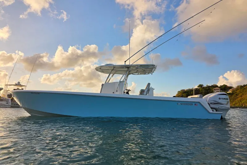 Slide: The Image of 2019 Contender 35 ST boat on water at sunset with Yamaha engines. - 1