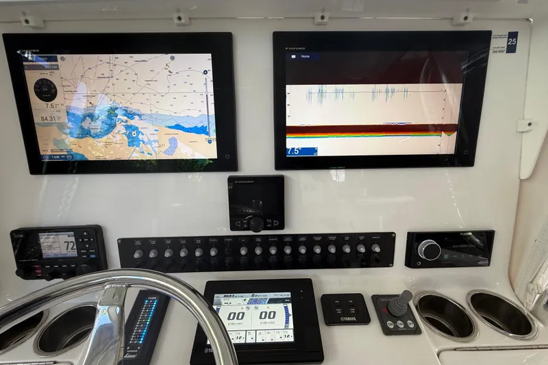 Slide: The Image of Control panel of a 2019 Contender 35 ST boat with navigation and sonar displays. - 10