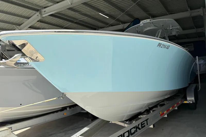 Slide: The Image of 2019 Contender 35 ST boat in storage, light blue hull, on a trailer. - 2