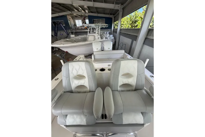Slide: The Image of 2019 Contender 35 ST boat interior with cushioned seating in a showroom. - 27