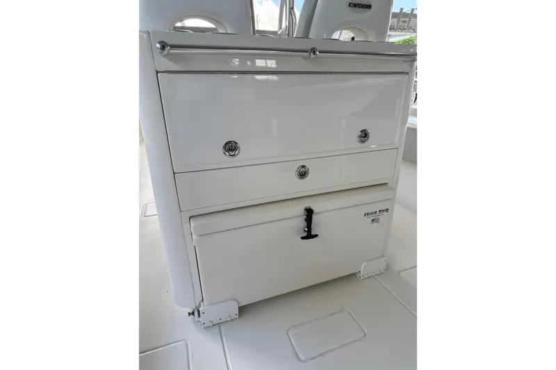 Slide: The Image of 2019 Contender 35 ST boat console with storage compartments and Frigid Rigid cooler. - 28