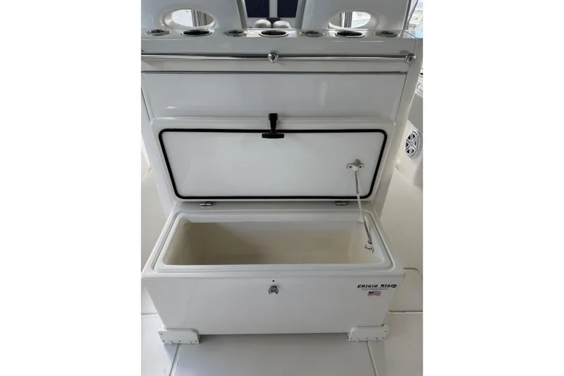 Slide: The Image of Open storage compartment on 2019 Contender 35 ST boat, featuring Frigid Rigid cooler. - 29