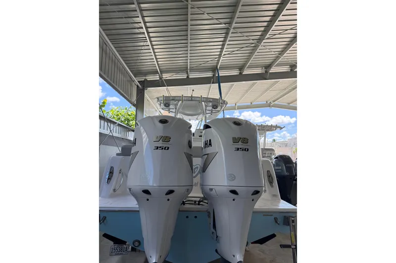 Slide: The Image of 2019 Contender 35 ST with twin Yamaha V8 350 engines in a covered dock. - 4