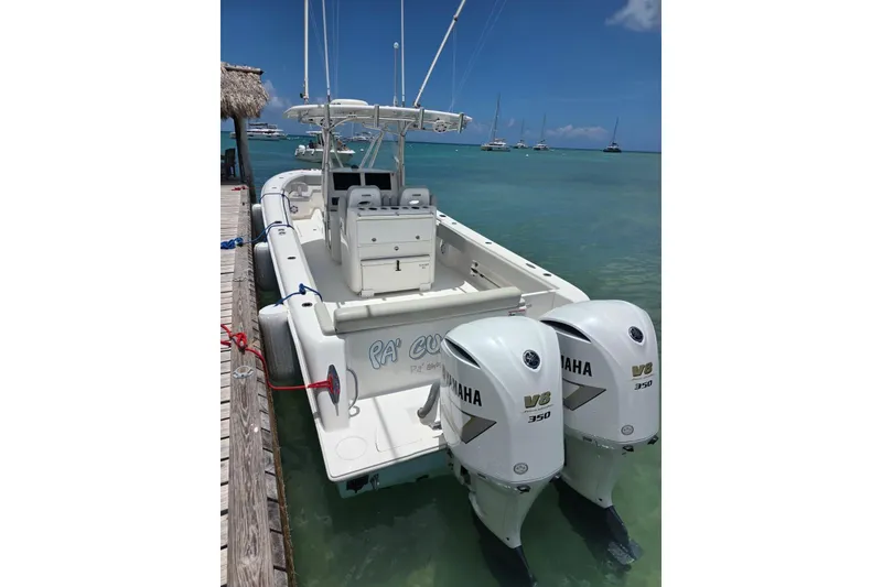 Slide: The Image of 2019 Contender 35 ST boat with twin Yamaha V8 350 engines docked in clear waters. - 6