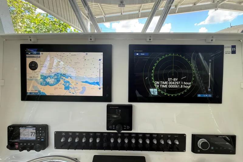 Slide: The Image of 2019 Contender 35 ST boat dashboard with navigation and radar displays. - 9