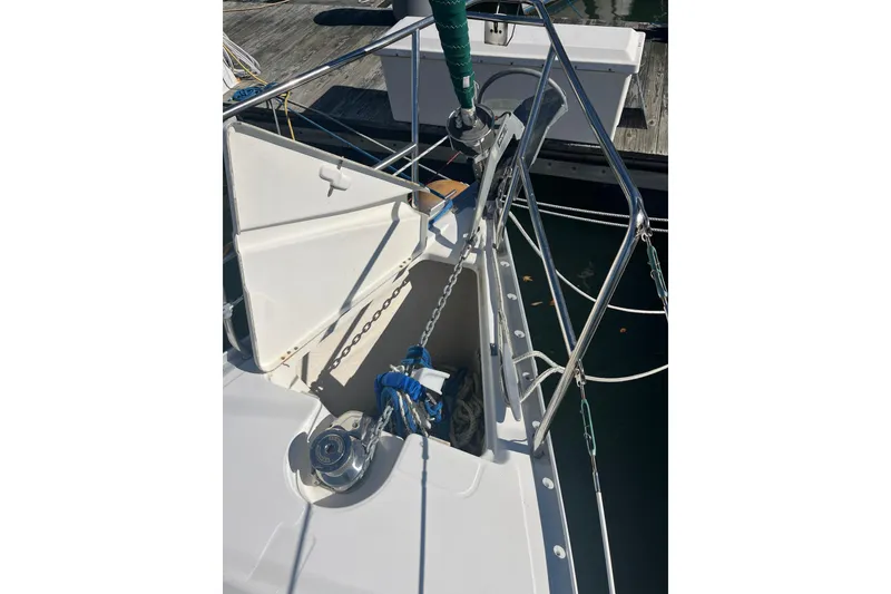 Slide: The Image of Bow of a 2004 Beneteau 331 sailboat with anchor chain and open hatch. - 10