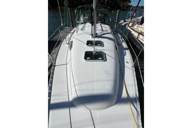 Slide: The Image of 2004 Beneteau 331 sailboat docked, showcasing sleek deck design and rigging. - 11