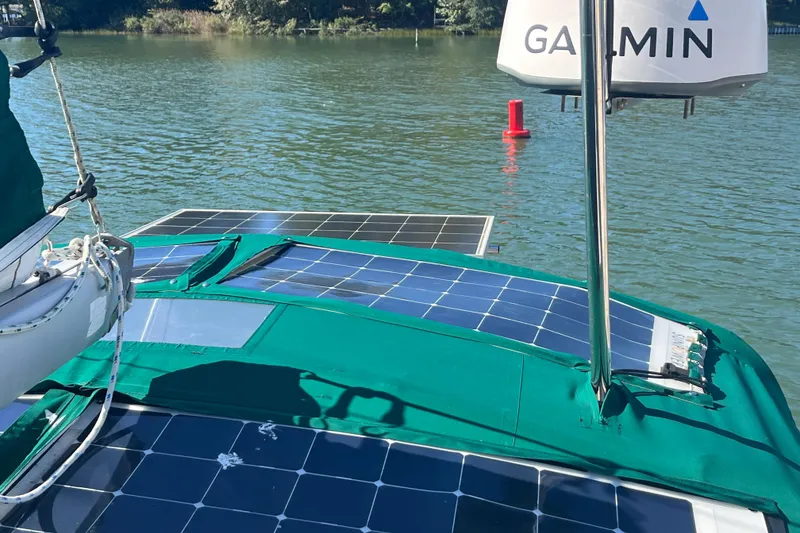 Slide: The Image of 2004 Beneteau 331 sailboat with solar panels and Garmin equipment on a calm lake. - 13