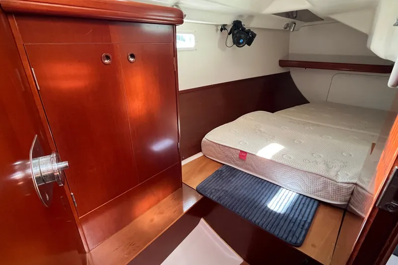 Slide: The Image of Cozy cabin interior of 2004 Beneteau 331 sailboat with wooden finish and comfortable bed. - 18