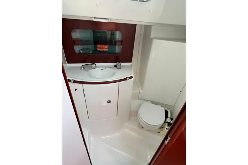 Slide: The Image of 2004 Beneteau 331 yacht bathroom with sink, mirror, and toilet. - 19