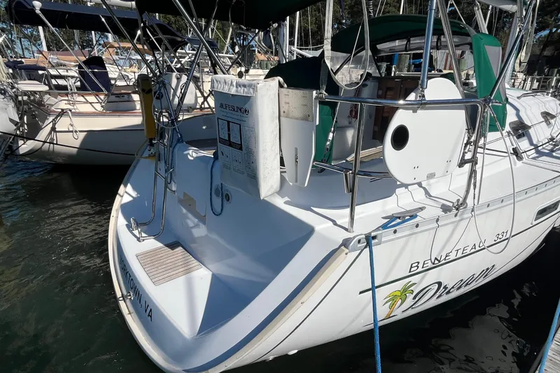 Slide: The Image of 2004 Beneteau 331 sailboat docked, featuring a clean deck and green canopy. - 4