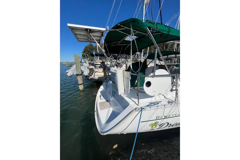 Slide: The Image of 2004 Beneteau 331 sailboat docked, featuring green canopy and solar panels. - 5