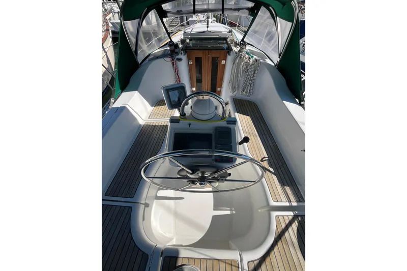 Slide: The Image of 2004 Beneteau 331 sailboat cockpit with steering wheel and navigation equipment. - 6