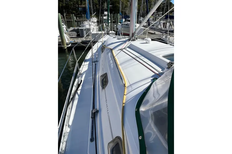 Slide: The Image of 2004 Beneteau 331 sailboat docked, showcasing deck and rigging details. - 8