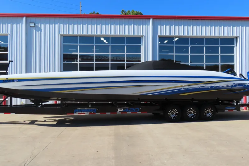 Slide: The Image of 2025 Performance Powerboats P420 on trailer, sleek design, parked outside a modern garage. - 2