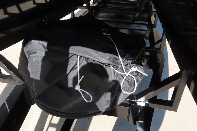 Slide: The Image of Black drawstring bag on Performance Powerboats P420, 2025 model, under metal framework. - 24