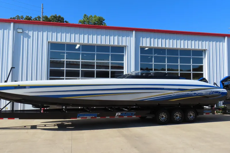 Slide: The Image of 2025 Performance Powerboats P420 on trailer outside a modern garage. - 27